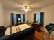 Comfortable bedroom with hardwood floors, soft lighting, and calming blue curtains at 860 19 N Ave, St Petersburg, FL 33704