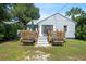 Charming home featuring a backyard deck with seating, accessible from a set of stairs, creating a cozy outdoor space at 860 19 N Ave, St Petersburg, FL 33704