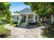 Charming bungalow home with blue siding, a welcoming front porch, and decorative landscaping at 860 19 N Ave, St Petersburg, FL 33704