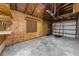 Interior of a spacious garage with plywood walls, concrete floors, and an automatic garage door opener at 860 19 N Ave, St Petersburg, FL 33704