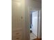 Hallway linen closet and view into bathroom with white tiled shower at 860 19 N Ave, St Petersburg, FL 33704