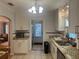 Well-appointed kitchen with stainless appliances, granite counters, and access to laundry area at 860 19 N Ave, St Petersburg, FL 33704
