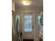 Laundry room with access to the backyard, stainless steel refrigerator, and white washer/dryer at 860 19 N Ave, St Petersburg, FL 33704