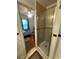 Tile shower with glass door, looking from bathroom into an adjacent bedroom at 860 19 N Ave, St Petersburg, FL 33704