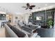 Living room with built-in shelving and view to screened patio at 4949 Grand Banks Dr, Wimauma, FL 33598