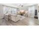 Spacious living room with gray walls, tile floors, and comfy seating at 2848 Gridiron Isle, New Port Richey, FL 34655