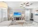 Bright living room with a sectional sofa, large TV and lots of natural light at 2848 Gridiron Isle, New Port Richey, FL 34655