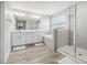 Bathroom with double vanity, soaking tub, and walk-in shower at 2848 Gridiron Isle, New Port Richey, FL 34655