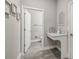 Clean and modern powder room with a pedestal sink and toilet at 2848 Gridiron Isle, New Port Richey, FL 34655