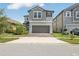 Two-story house with gray siding, two-car garage, and landscaped front yard at 2848 Gridiron Isle, New Port Richey, FL 34655