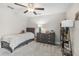 Cozy bedroom featuring a twin bed, dresser and shelving unit at 2848 Gridiron Isle, New Port Richey, FL 34655