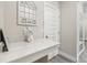 Modern vanity with white quartz countertop and decorative mirror at 2848 Gridiron Isle, New Port Richey, FL 34655