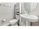 Small powder room with a pedestal sink, toilet and storage cabinet at 2848 Gridiron Isle, New Port Richey, FL 34655