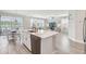 Open kitchen with large island, stainless steel appliances, and view of living room at 2848 Gridiron Isle, New Port Richey, FL 34655