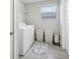 Laundry room with washer, dryer, and storage shelving at 2848 Gridiron Isle, New Port Richey, FL 34655