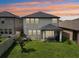 Two-story house with screened patio and grassy backyard at 2848 Gridiron Isle, New Port Richey, FL 34655
