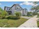 Two-story house with gray siding, two-car garage, and manicured lawn at 2848 Gridiron Isle, New Port Richey, FL 34655