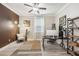 Home office with a desk, shelving, and comfortable seating area at 2848 Gridiron Isle, New Port Richey, FL 34655