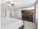 Main bedroom with king bed and large TV showcasing desert landscape at 2848 Gridiron Isle, New Port Richey, FL 34655