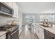 Modern kitchen with stainless steel appliances and white cabinetry at 2848 Gridiron Isle, New Port Richey, FL 34655