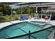 Inviting pool area with spa and screened enclosure at 11621 Salmon Dr, Port Richey, FL 34668