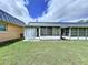 A view of the back of the house highlighting the patio with white trim at 11920 Boynton Ln # 11920, New Port Richey, FL 34654
