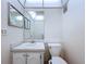Simple bathroom featuring a vanity with mirror and a toilet at 11920 Boynton Ln # 11920, New Port Richey, FL 34654