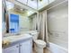 Bathroom with decorative mirror, vanity, tiled walls, and shower/tub with curtain at 11920 Boynton Ln # 11920, New Port Richey, FL 34654