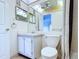 Bathroom featuring a vanity with a large mirror, toilet, and a shower-tub combo with a shower curtain at 11920 Boynton Ln # 11920, New Port Richey, FL 34654