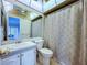 The bathroom has a modern vanity, tiled walls, and a shower/tub with curtain at 11920 Boynton Ln # 11920, New Port Richey, FL 34654