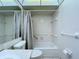 Bright bathroom featuring a shower-tub combo with white tile and a neutral-toned shower curtain at 11920 Boynton Ln # 11920, New Port Richey, FL 34654