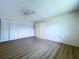 Bright bedroom featuring closet with louvered doors and vinyl floors at 11920 Boynton Ln # 11920, New Port Richey, FL 34654