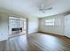 Bedroom has wood-look floors, bright windows and a sliding glass door to an enclosed porch at 11920 Boynton Ln # 11920, New Port Richey, FL 34654