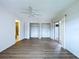 An empty bedroom with wood floors has a ceiling fan, a patio door and a closet at 11920 Boynton Ln # 11920, New Port Richey, FL 34654
