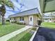 Well-maintained homes with metal roofs, manicured lawns, and convenient carport parking at 11920 Boynton Ln # 11920, New Port Richey, FL 34654