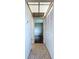Hallway with tile floors and closet with louvered doors, leading to living area at 11920 Boynton Ln # 11920, New Port Richey, FL 34654