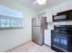 Well-lit kitchen featuring white cabinets and stainless steel appliances at 11920 Boynton Ln # 11920, New Port Richey, FL 34654