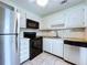 Kitchen area with white cabinets and stainless steel refrigerator and dishwasher at 11920 Boynton Ln # 11920, New Port Richey, FL 34654