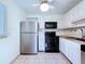 Functional kitchen with stainless steel refrigerator and black appliances at 11920 Boynton Ln # 11920, New Port Richey, FL 34654