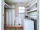 Utility room with pegboard, washer and dryer, and storage shelving, offering practical functionality at 11920 Boynton Ln # 11920, New Port Richey, FL 34654