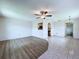 Open living area showcasing the stylish flooring, modern ceiling fan, and seamless transition to the kitchen at 11920 Boynton Ln # 11920, New Port Richey, FL 34654
