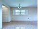 Bright living room featuring tile floors and a window with white shutters at 11920 Boynton Ln # 11920, New Port Richey, FL 34654