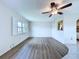 Living area with new flooring, natural light, and a view to the kitchen at 11920 Boynton Ln # 11920, New Port Richey, FL 34654