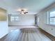 Inviting living room boasts natural light, new flooring, and a ceiling fan at 11920 Boynton Ln # 11920, New Port Richey, FL 34654