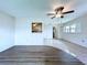 Bright living room with new wood flooring, ceiling fan, and a view into the kitchen area at 11920 Boynton Ln # 11920, New Port Richey, FL 34654