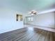 Sun-filled living room featuring a ceiling fan, and updated flooring at 11920 Boynton Ln # 11920, New Port Richey, FL 34654