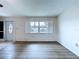 Sunny living room featuring bright windows and updated flooring at 11920 Boynton Ln # 11920, New Port Richey, FL 34654