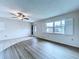 Well-lit living room with new flooring, ceiling fan, and a view of the outdoors at 11920 Boynton Ln # 11920, New Port Richey, FL 34654