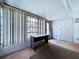Enclosed room with paneled walls, windows, and a door, suitable as a sunroom or office at 11920 Boynton Ln # 11920, New Port Richey, FL 34654