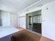 Enclosed room with paneled walls, a sliding glass door, and carpeted floor, offering versatile space at 11920 Boynton Ln # 11920, New Port Richey, FL 34654